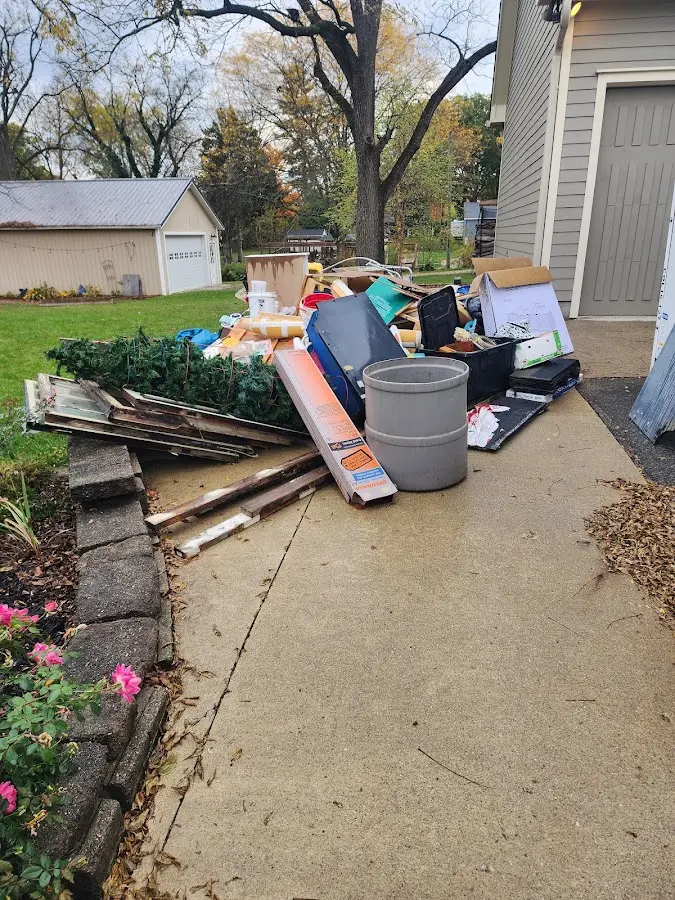 Dumpster being loaded with debris for Estate Cleanout Dumpster Rental in Moravia